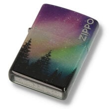 A Zippo lighter with colourful sky design in green and purple with tree sillouhette