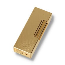 A gold dunhill lighter with barley textured design