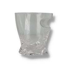 A whisky glass with a built in cigar rest